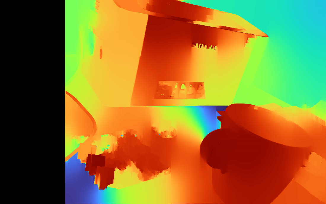 Colour-mapped disparity image from the real stereo pair, with the mug and circuit board reading as near and the walls as far.